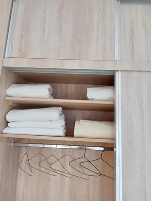 a wooden cabinet with white towels on it at Résidence Al Qaraouiyine in Fès
