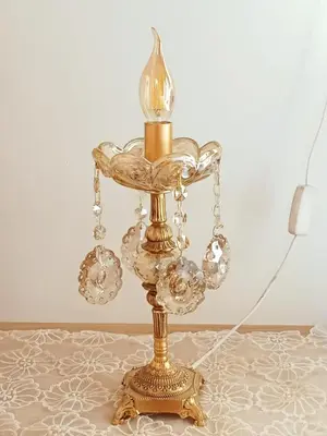 a glass lamp with a candle on a table at Résidence Al Qaraouiyine in Fès