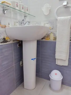 a white sink in a bathroom with blue tiles at Résidence Al Qaraouiyine in Fès