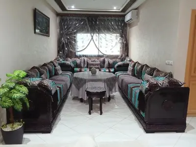 a living room with a couch and a table at Résidence Al Qaraouiyine in Fès