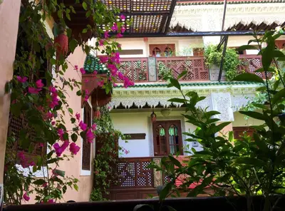 a building with flowers on the side of it at Riad Toyour- Riad of birds in Fès