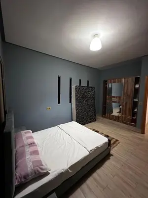 a bedroom with a bed and a blue wall at Villa élégante in Meknès