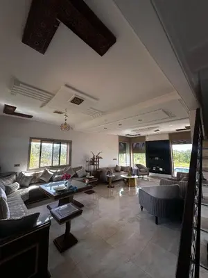 a large living room with couches and a tv at Villa élégante in Meknès