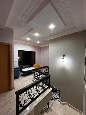 a living room with stairs and a living room at Villa élégante in Meknès