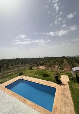 a swimming pool with a view of a field at Villa élégante in Meknès