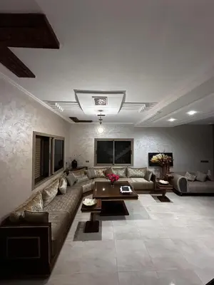 a large living room with a couch and a table at Villa élégante in Meknès