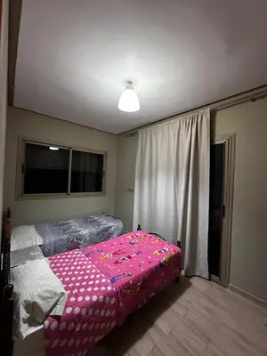 a bedroom with a pink bed and a window at Villa Lina in Meknès
