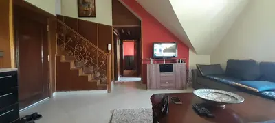 a living room with a couch and a tv at Résidence la Gazelle 0-6-1-7-6-1-3-8-7-3 in Ifrane