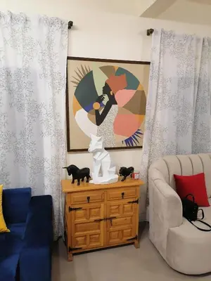 a living room with a couch and a cat statue on a table at Ferme d'hôtes Aghbalou in Sefrou