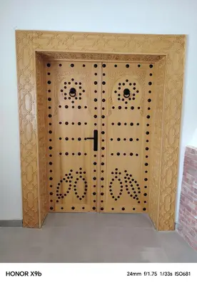 a wooden door with a gate in a room at Ferme d'hôtes Aghbalou in Sefrou