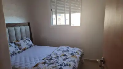 a bed in a bedroom with a window at Bel appartement à louer in Ifrane