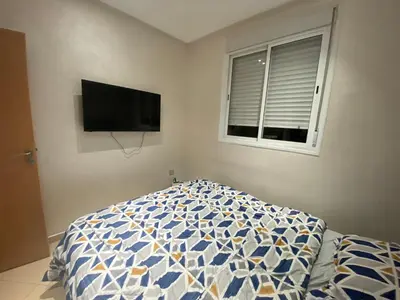 a bedroom with a bed and a tv on the wall at Bel appartement à louer in Ifrane