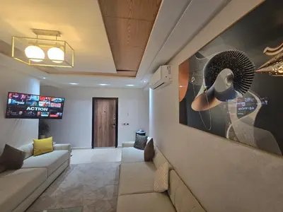 a living room with a couch and a tv at Bel appartement à louer in Ifrane