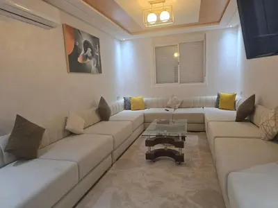 a living room with a couch and a table at Bel appartement à louer in Ifrane