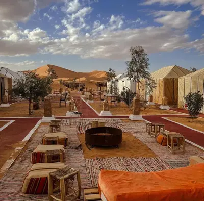 a group of tables and tents in the desert at Sahara Authentic Camp in Merzouga