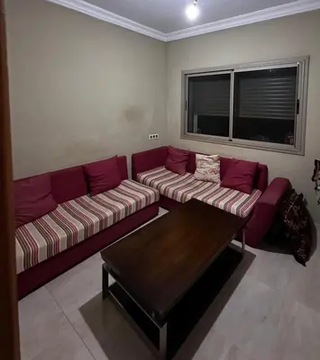 a living room with a couch and a coffee table at Villa élégante in Aït Ali Ou Moussa
