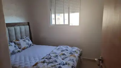 a bed in a bedroom with a window at Appartement luxueux in Ifrane