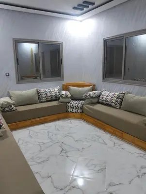 a living room with two couches and a marble floor at Location AZROU in Azrou
