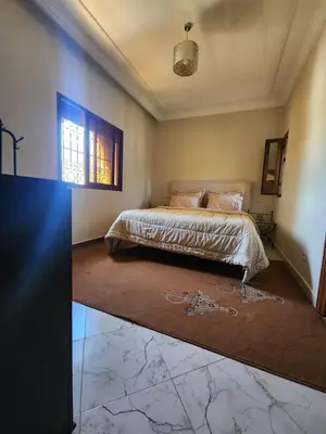 a bedroom with a bed in the corner of a room at La dolce villa in Sidi Bouzguia