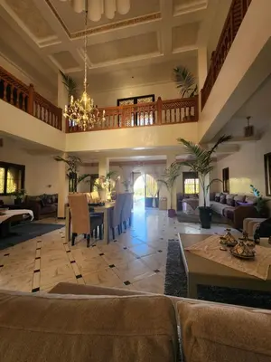 a living room with a couch and a table at La dolce villa in Sidi Bouzguia