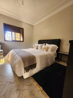 a bedroom with a large bed and a window at La dolce villa in Sidi Bouzguia
