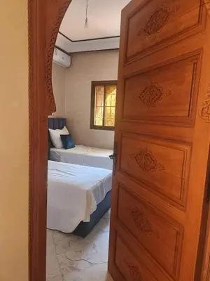 a door leading to a bedroom with two beds at La dolce villa in Sidi Bouzguia