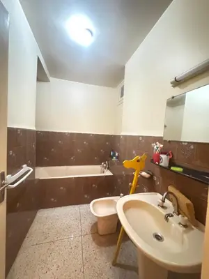 a bathroom with a sink and a toilet at Maison traditionnelle