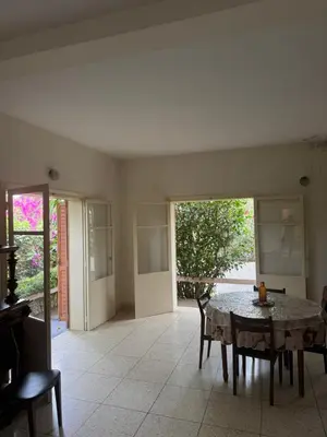 a dining room with a table and chairs and a window at Maison traditionnelle