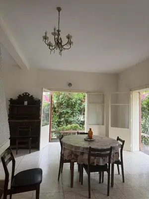a dining room with a table and chairs and a chandelier at Maison traditionnelle