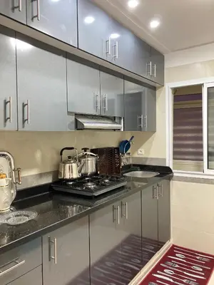 a kitchen with stainless steel cabinets and a stove at Cozy apartment in Ifrane in Ifrane