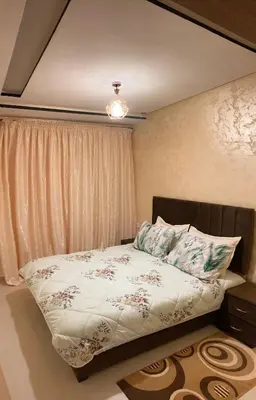 a bedroom with a bed with a pillow and a window at Cozy apartment in Ifrane in Ifrane