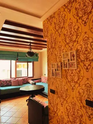 a living room with a couch and a table at Apartment in Ouedlaou in Oulad Akkou
