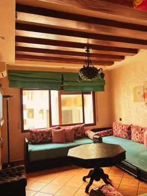 a living room with a couch and a table at Apartment in Ouedlaou in Oulad Akkou
