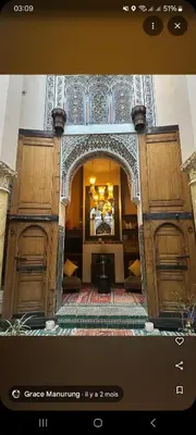 a room with two large wooden doors in a room at Riad Victoria in Fès