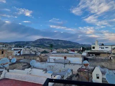 a view of a city with a mountain in the background at Riad Victoria in Fès