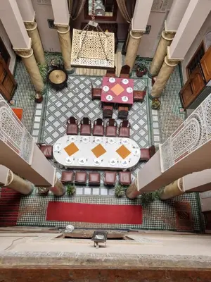 an overhead view of a table and chairs in a building at Riad Victoria in Fès