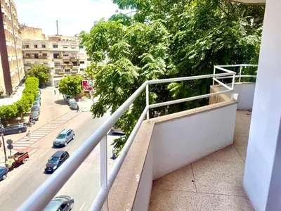 a balcony of a building with a view of a street at Appartement centre ville avec Wifi 100Mo in Fès