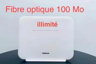 a laptop computer sitting on top of a table at Appartement centre ville avec Wifi 100Mo in Fès