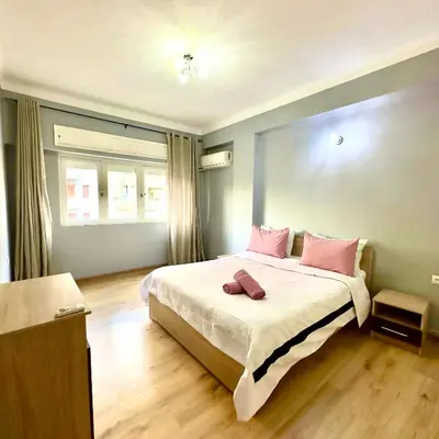 a bedroom with a large bed with pink pillows at Appartement centre ville avec Wifi 100Mo in Fès