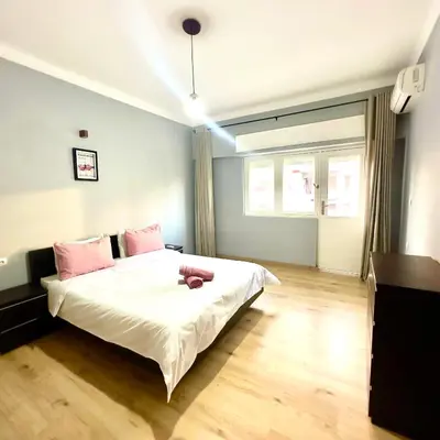a bedroom with a large white bed with pink pillows at Appartement centre ville avec Wifi 100Mo in Fès