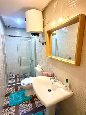 a bathroom with a sink and a toilet and a mirror at Appartement centre ville avec Wifi 100Mo in Fès