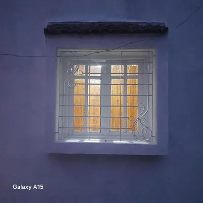 a window of a building with bars on it at Maison d'Azur in Imouzzer Kandar
