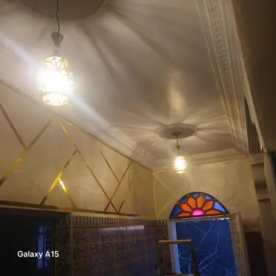 a room with two lights and a stained glass window at Maison d'Azur in Imouzzer Kandar