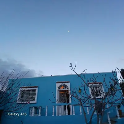 a blue building with a door and two windows at Maison d'Azur in Imouzzer Kandar