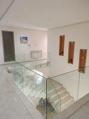 a glass stair case in a room with stairs at Villa in Meknès