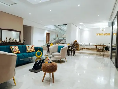 a living room with a blue couch and chairs at Villa in Meknès