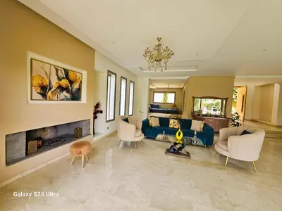 a living room with a blue couch and a fireplace at Villa in Meknès