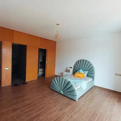 a bedroom with a bed with a circular headboard at Villa in Meknès