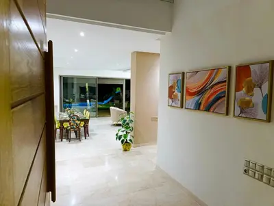 a hallway of a home with paintings on the wall at Villa in Meknès