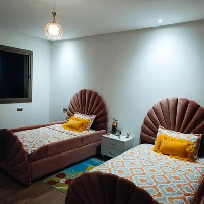 a bedroom with two beds and a couch at Villa in Meknès